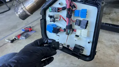 Starter / junction-box area — tagged loom for later identification.