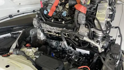 Engine suspended at the bay — tilt and clearance for lowering in.