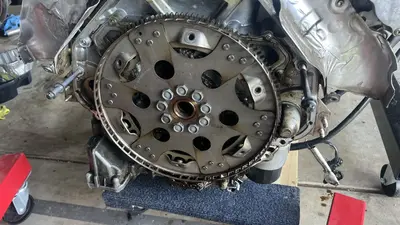 Out of the car: flexplate still on the crank — oily residue at the rear of the block and pan.
