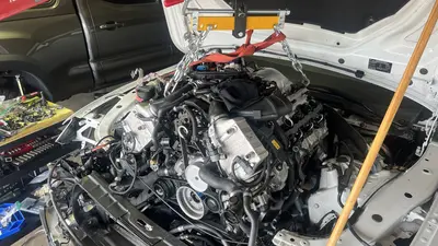 Hoist install progress — engine tilted for radiator-support clearance.