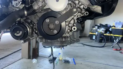 Harmonic balancer installed — BMW markings visible on the pulley.