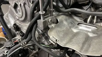 Long bolts for the alternator in place; first screw in for the forward heat shield.
