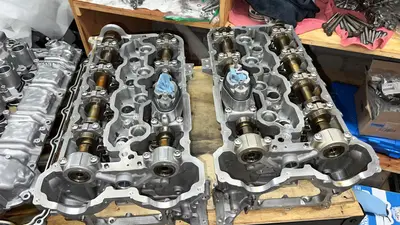 Heads with new valve seals, springs, and cams — assembled and ready for the block.