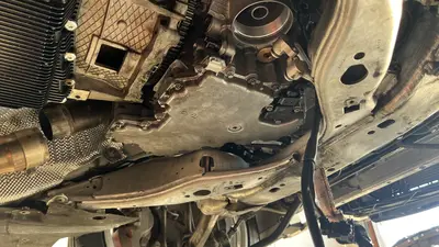 Underside reference — oil-pan bolts and electrical connectors.