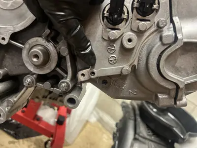 Pointing out the missing cover bolt