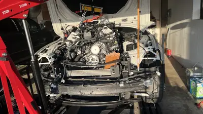Front of the engine in the bay — serpentine belt and pulley stack.