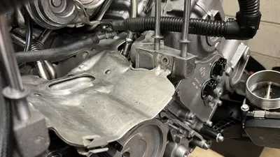 Heat shield and nearby hoses on the dressed long block.