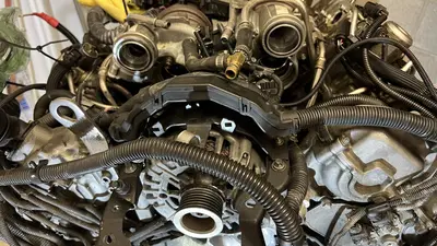 Still dressed on top: hot-V turbos in the valley, alternator up front, loom and hoses everywhere.