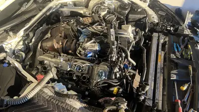 Bank 1 as of Oct 13: harnesses unplugged and tape-labeled, intercooler out, valve cover next.
