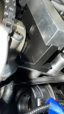 Close-up: the block's foot sits flat on the head with the cam flat engaged — no gap.